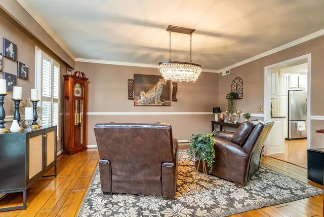 a living room with furniture a fireplace and dining table