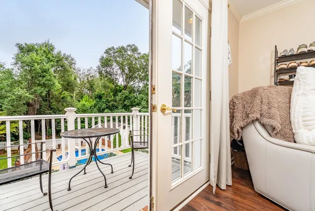 a view of a balcony with chair and wooden floor