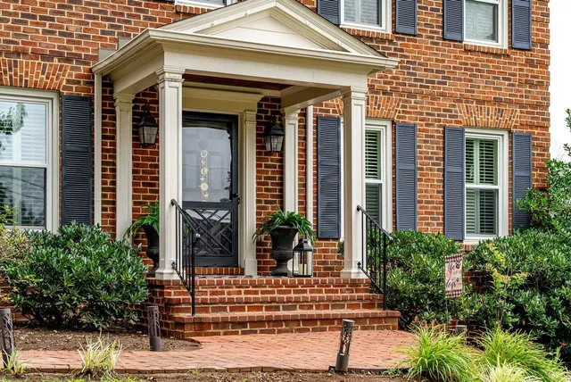 front view of a brick house with a large window