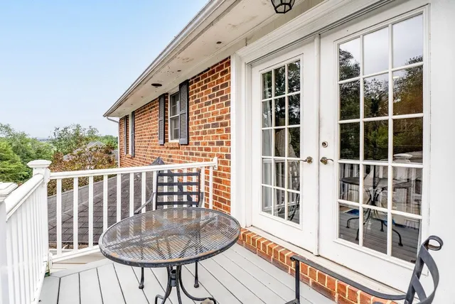 a view of a hallway with wooden floor and entryway