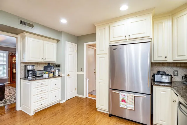 a white refrigerator freezer and a stove in a kitchen