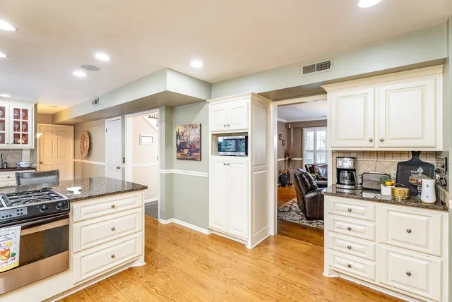 a kitchen with stainless steel appliances granite countertop a stove and a sink
