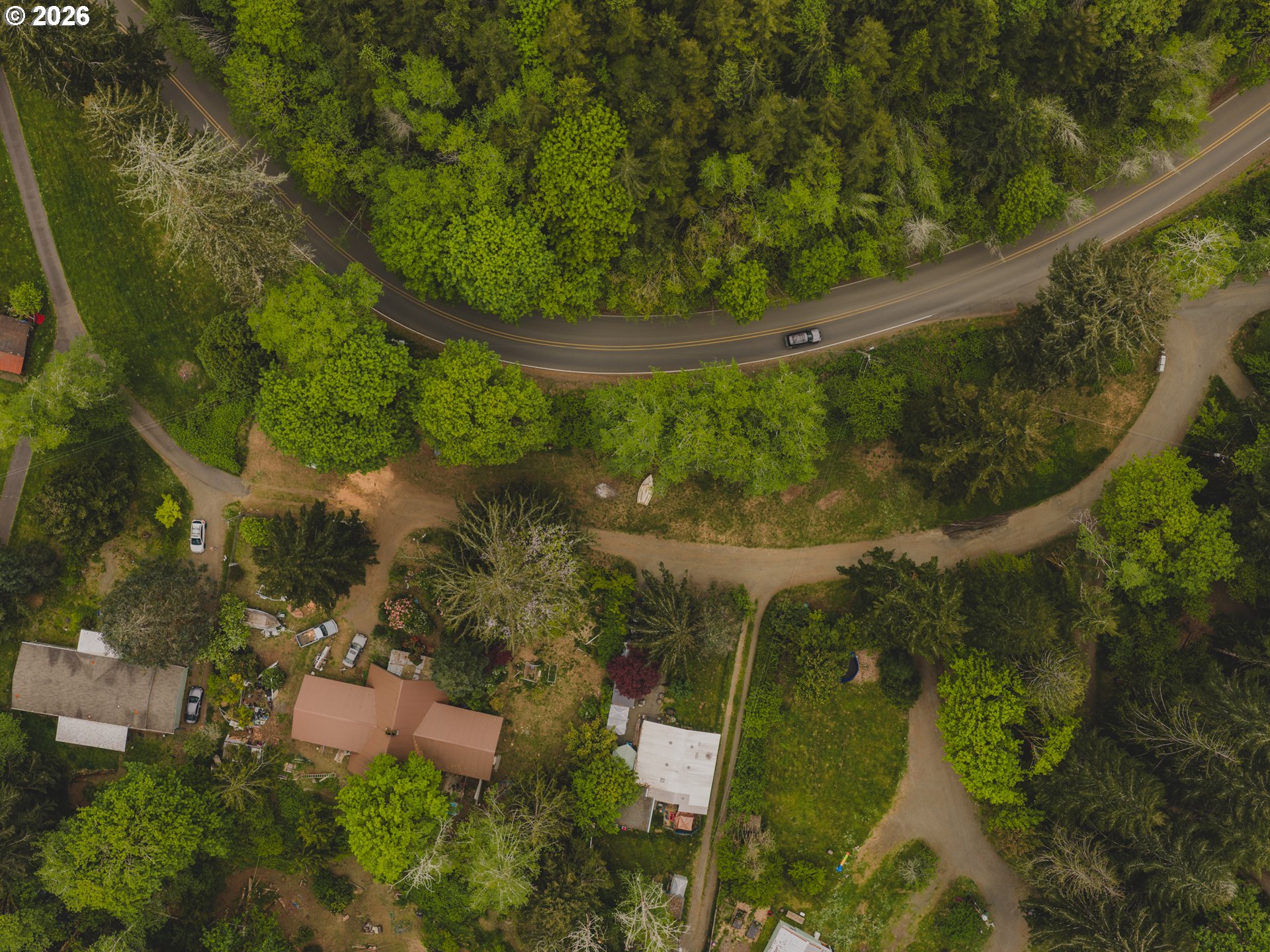 1100 North New Bridge Road Otis, OR 97368 - Photo 2 of 28 an aerial view of a residential houses with outdoor space and trees