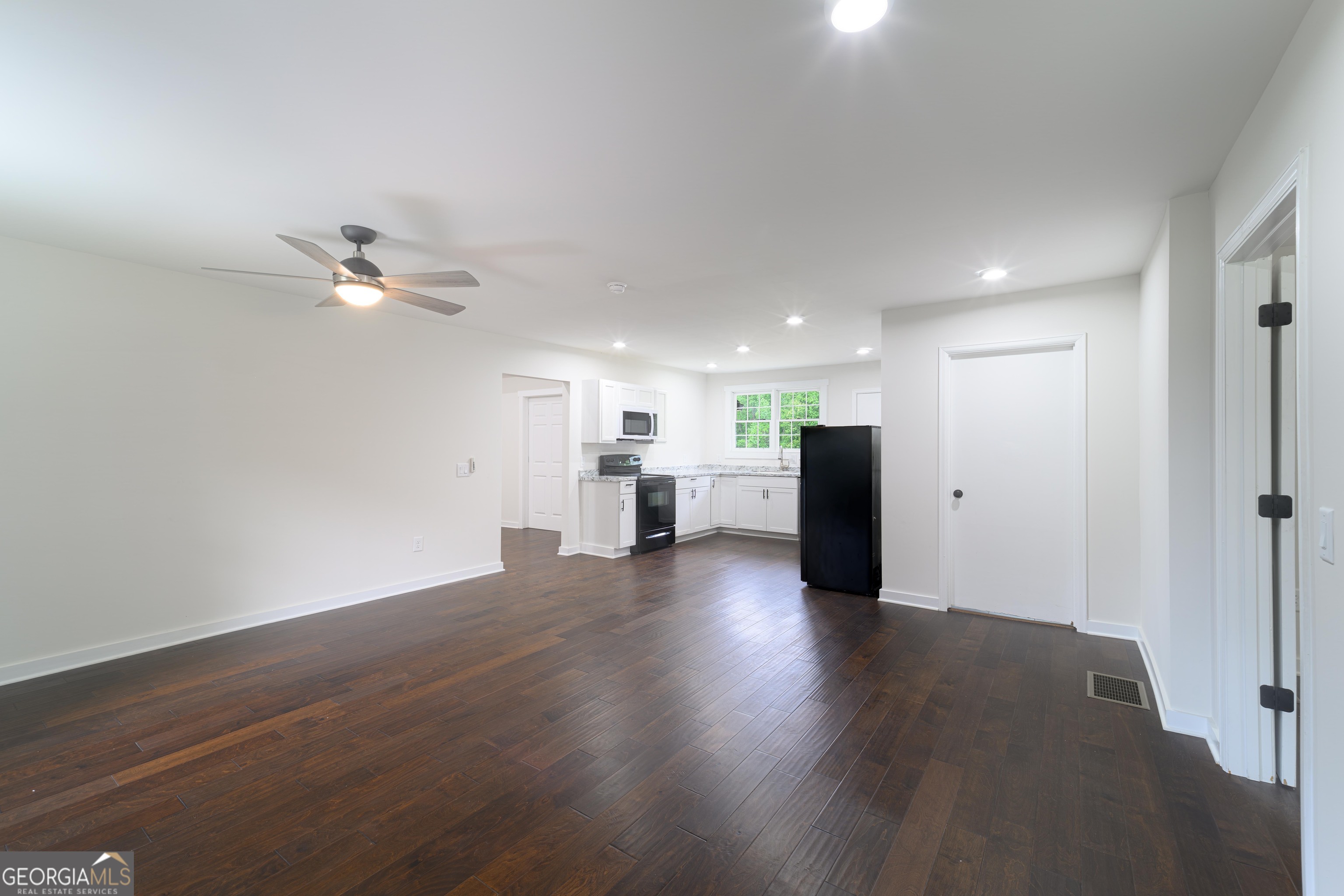 418 Lamb Road Moreland, GA 30259 - Photo 9 of 32 a view of an empty room with wooden floor and a ceiling fan