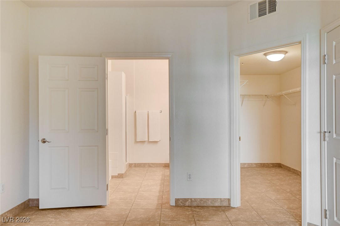 2291 West Horizon Ridge Parkway, Unit 7138 Henderson, NV 89052 - Photo 18 of 34 Primary bedroom has an ensuite bathroom and large closet.
