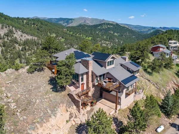 an aerial view of a house with mountain view