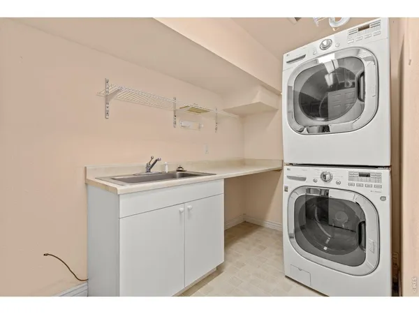 a utility room with sink dryer and washer