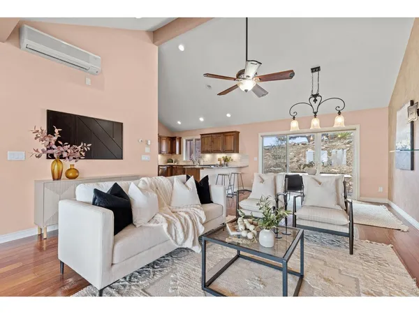 a living room with furniture a fireplace and a chandelier