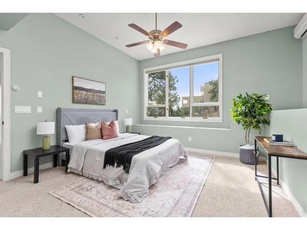 a bedroom with a large bed and a large window