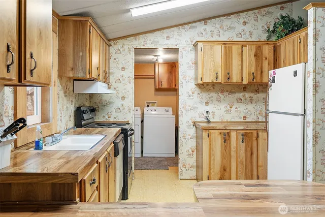 a kitchen with a sink a refrigerator and a stove