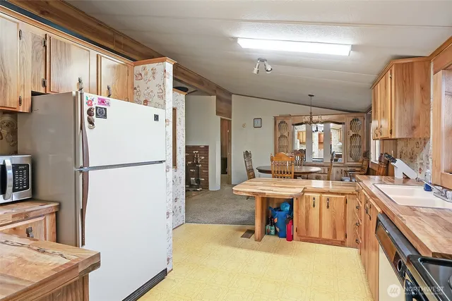 a white refrigerator freezer sitting in a kitchen