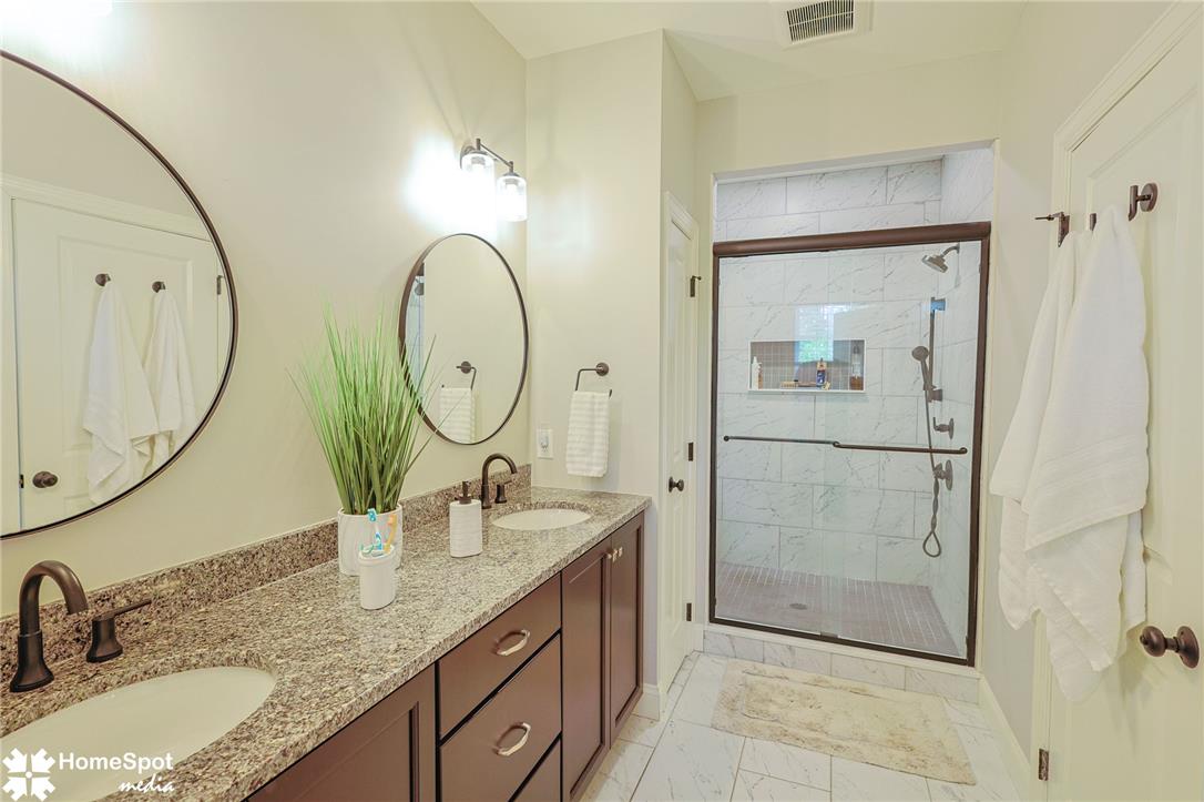 4518 Old Saucon Road Bethlehem, PA 18015 - Photo 10 of 19 Granite counters and dual sinks elevate this modern bath, complemented by a sleek walk-in shower.