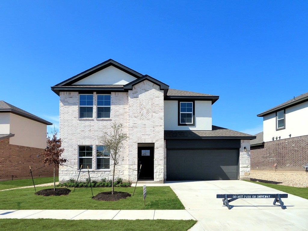 a front view of a house with yard