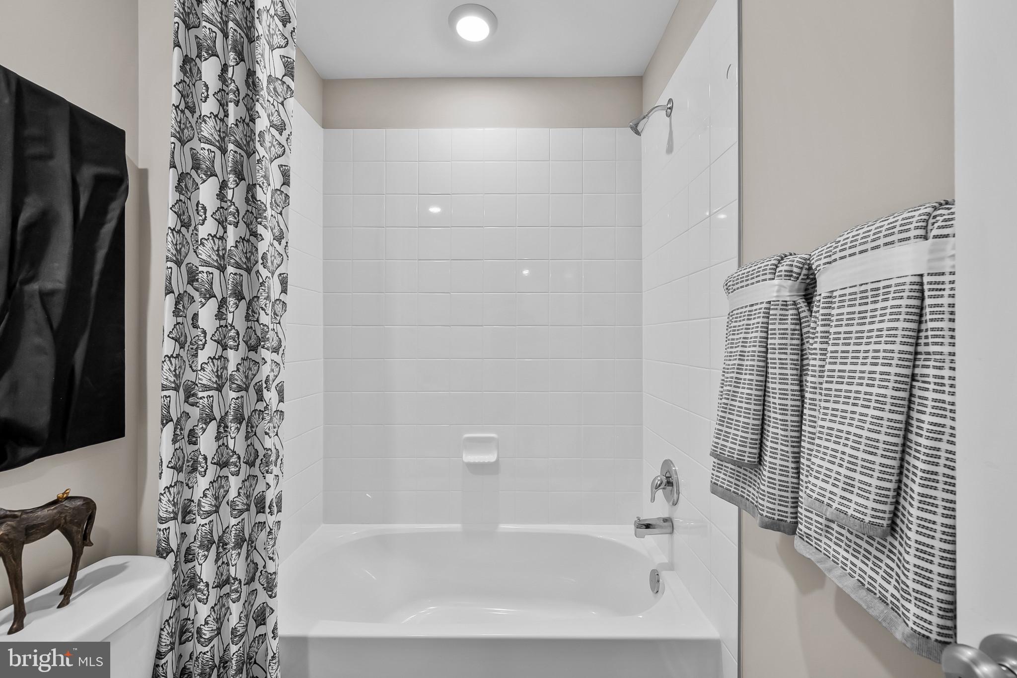 409 Eclipse Street Ranson, WV 25438 - Photo 23 of 46 a bathroom with a bathtub and shower