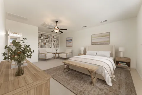 a spacious bedroom with a bed and a flat screen tv