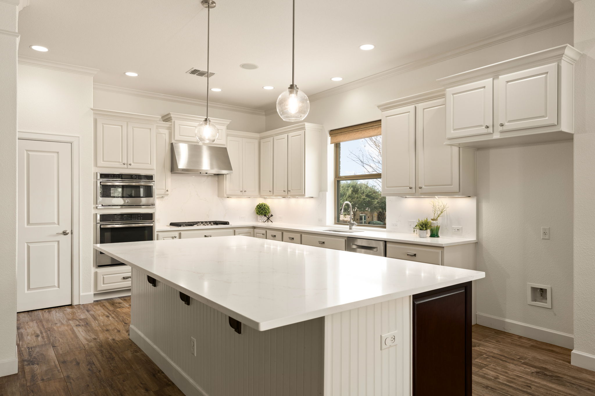 5701 Cherokee Draw Road Austin, TX 78738 - Photo 15 of 33 The kitchen offers a massive island, new quartz counters and backsplash, stainless steel appliances, and new lighting.