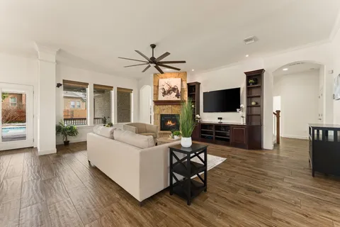 a large kitchen with kitchen island a stove a sink a center island and wooden floor