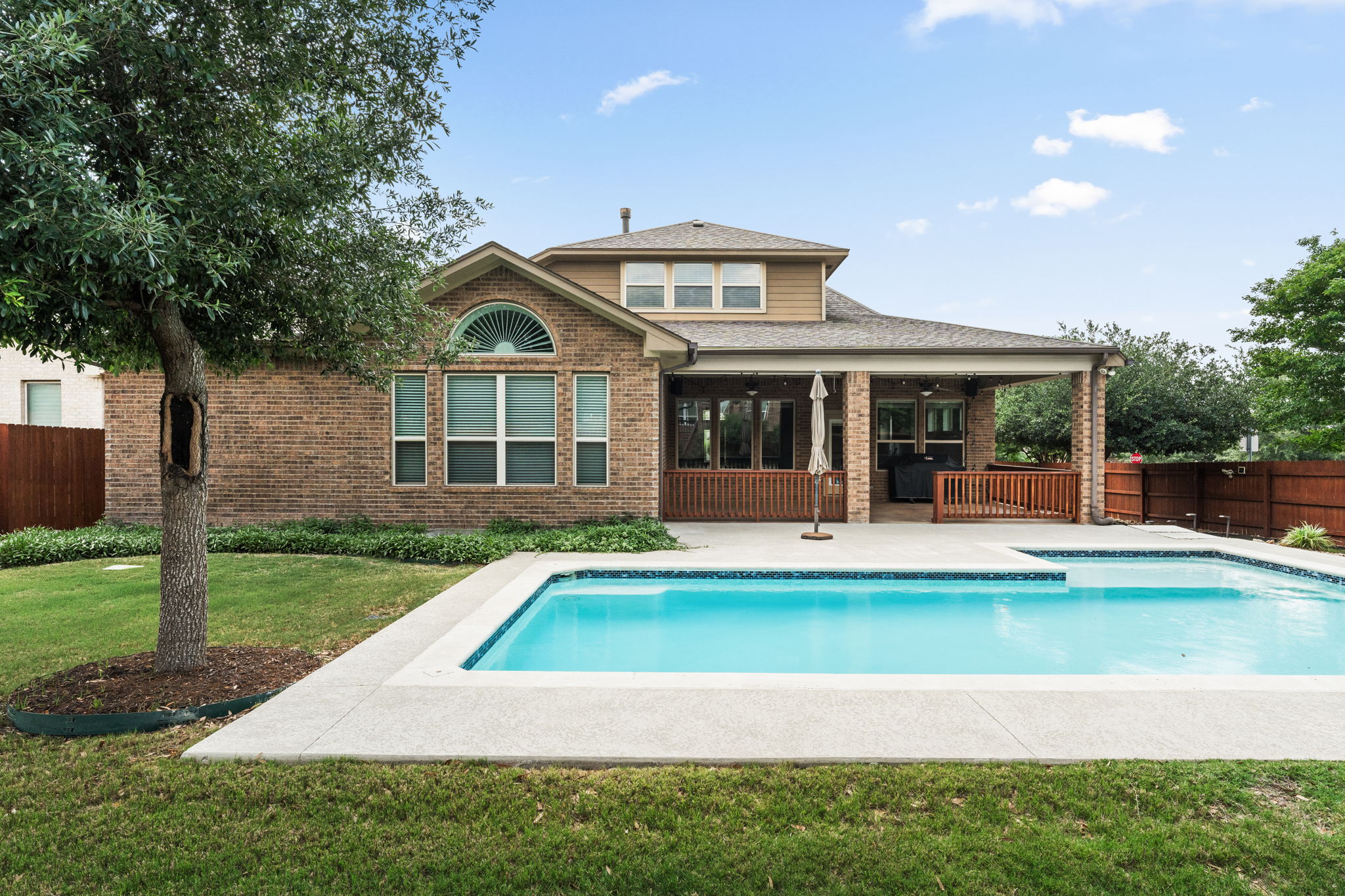 5701 Cherokee Draw Road Austin, TX 78738 - Photo 17 of 33 The backyard has an incredible oversized covered patio with plenty of green space and stunning landscaping.