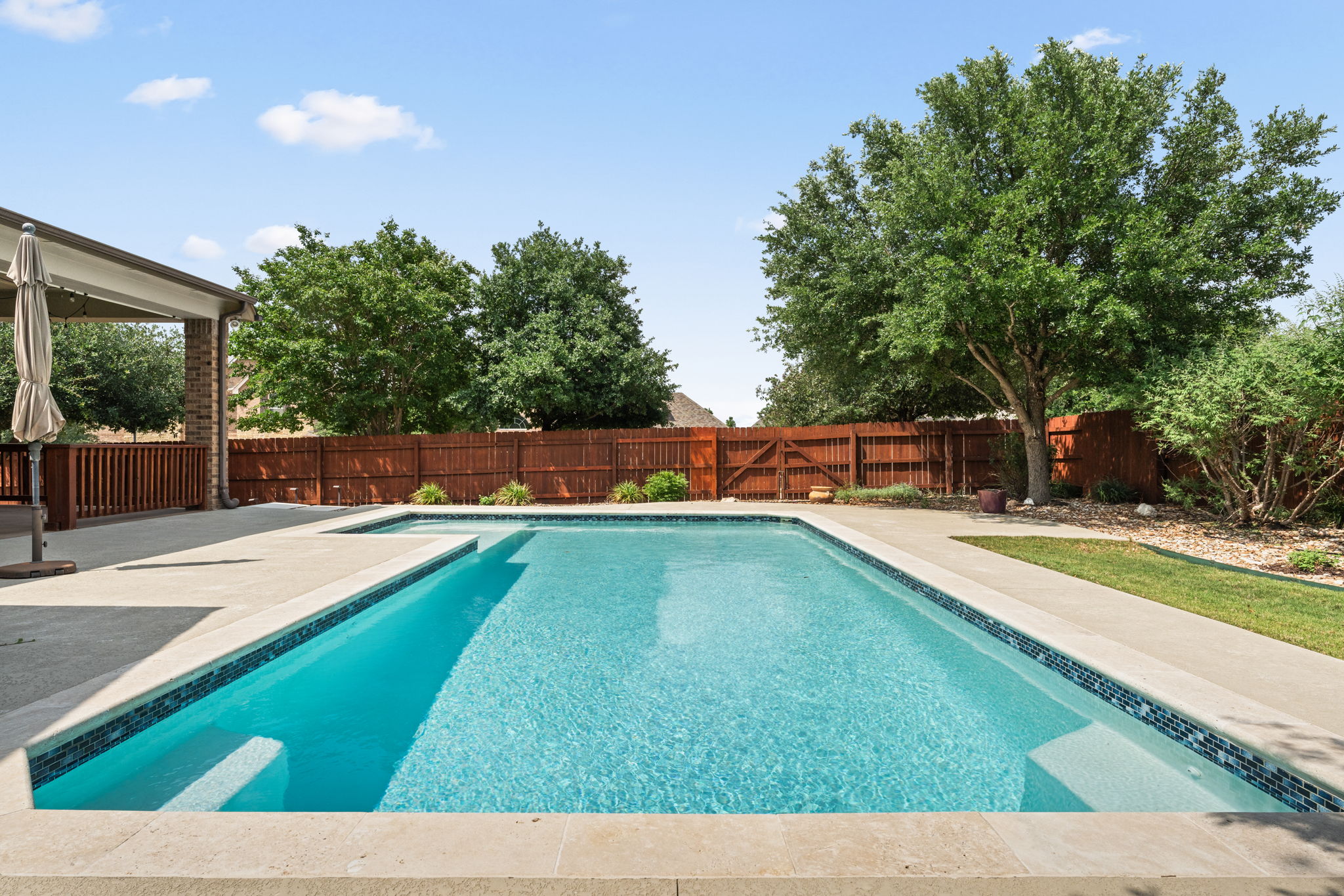 5701 Cherokee Draw Road Austin, TX 78738 - Photo 2 of 33 The spacious 0.29-acre corner lot features a sparkling pool.