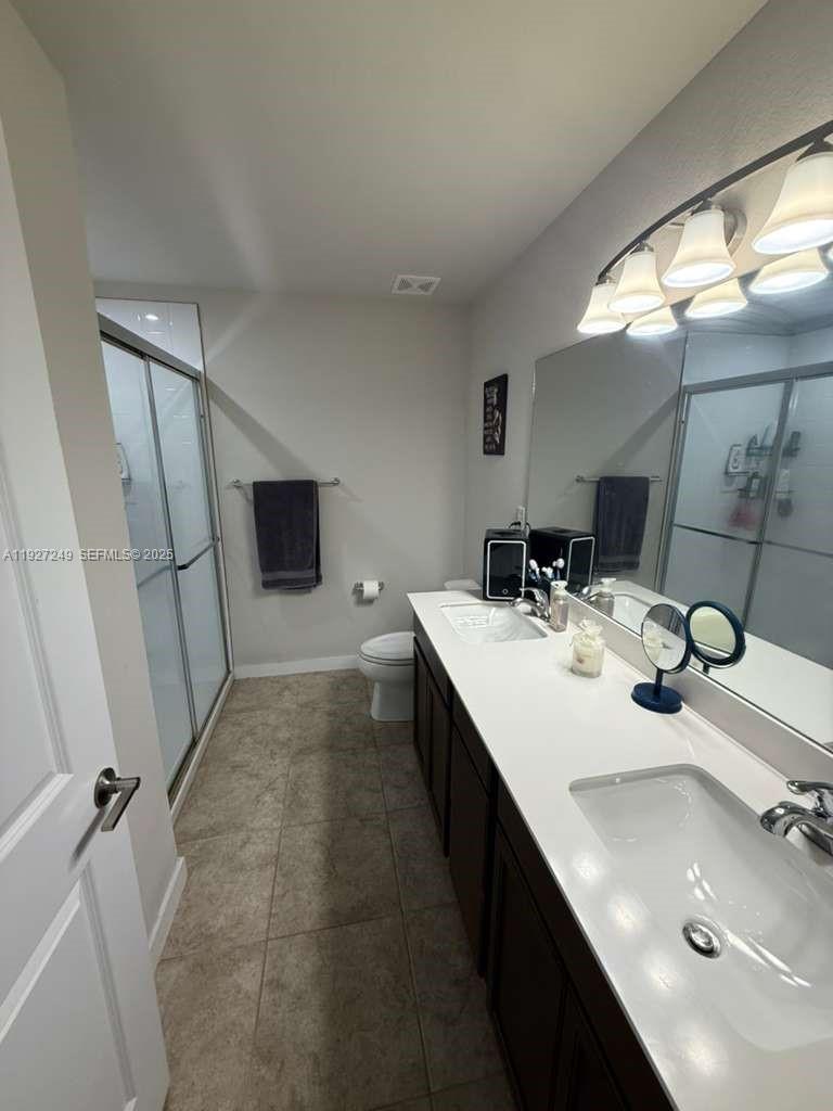 1037 Northwest 5th Street, Unit 1037 Florida City, FL 33034 - Photo 13 of 14 a bathroom with a sink and a mirror