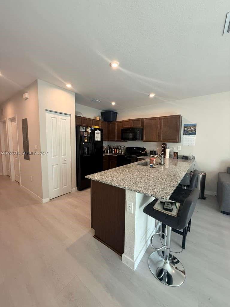 1037 Northwest 5th Street, Unit 1037 Florida City, FL 33034 - Photo 2 of 14 a living room with stainless steel appliances kitchen island granite countertop furniture and a kitchen view