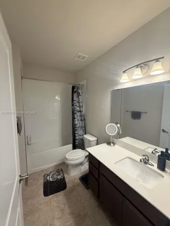 a bathroom with a double vanity sink toilet and shower