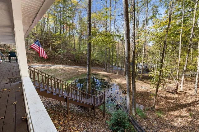 a view of balcony with wooden floor and fence