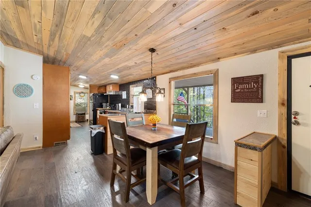 a dining room with furniture window and wooden floor