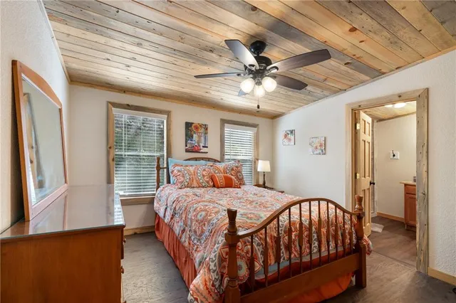 a bedroom with a large bed chandelier and a window