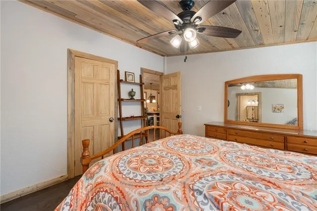 a bedroom with a large bed and a chandelier