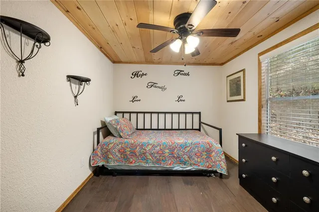 a bed sitting in a bedroom next to a window