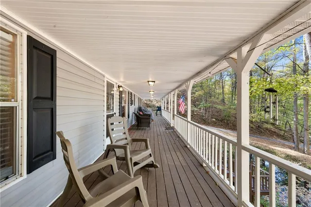 a view of a chairs and table in the balcony