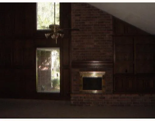 a view of an empty room with a fireplace