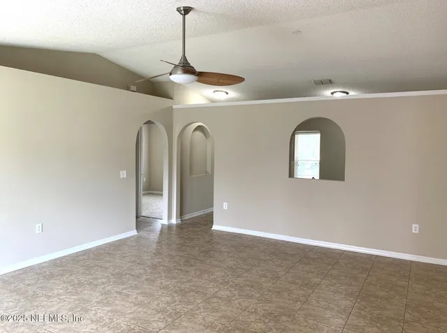 a view of a livingroom with a chandelier fan
