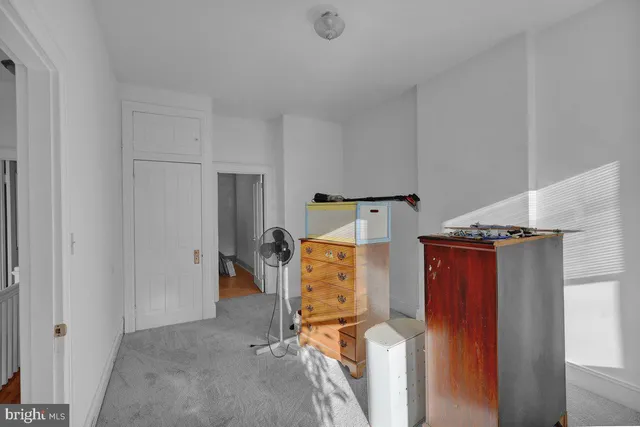 a room with furniture a rug and a window