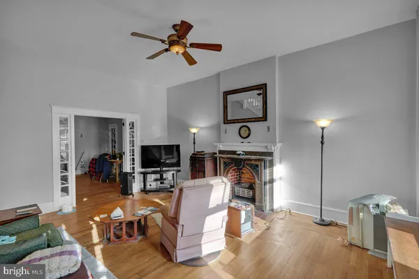 a living room with furniture a fireplace and a flat screen tv
