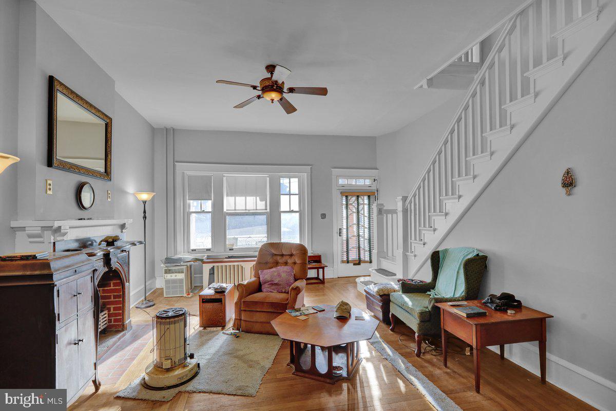 161 West High Street Womelsdorf, PA 19567 - Photo 8 of 37 a living room with furniture a fireplace and a flat screen tv