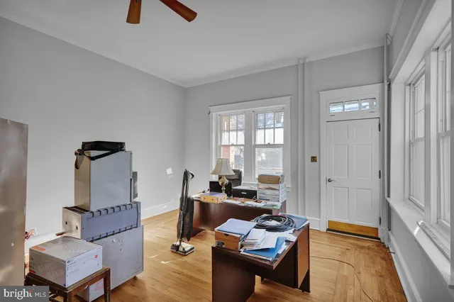 a view of a room with wooden floor and gym equipment