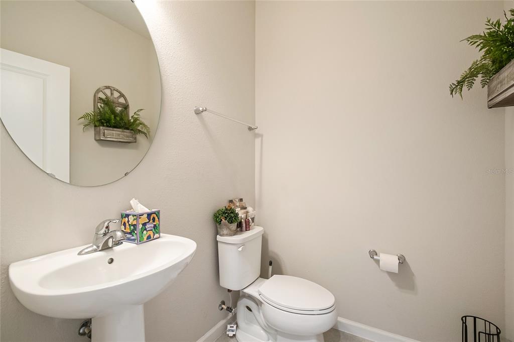 1943 Holden Ridge Ln. Clermont, FL 34715 - Photo 11 of 59 a bathroom with a sink mirror and toilet