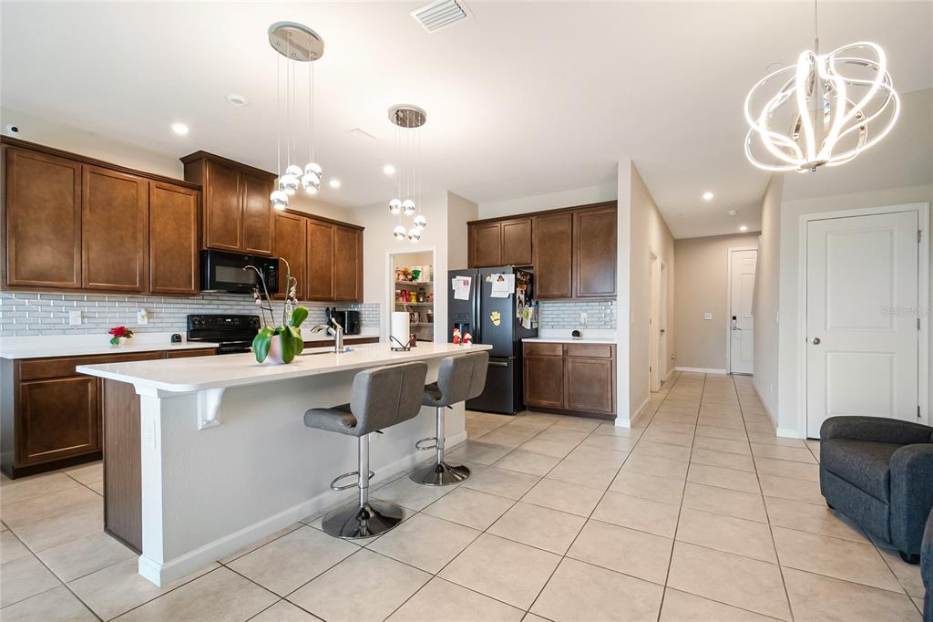 1943 Holden Ridge Ln. Clermont, FL 34715 - Photo 14 of 59 a kitchen with a sink a counter top space appliances and cabinets