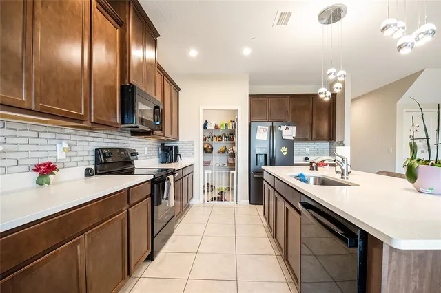 a living room with furniture and kitchen view