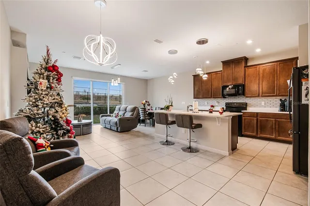 a living room with furniture and a floor to ceiling window