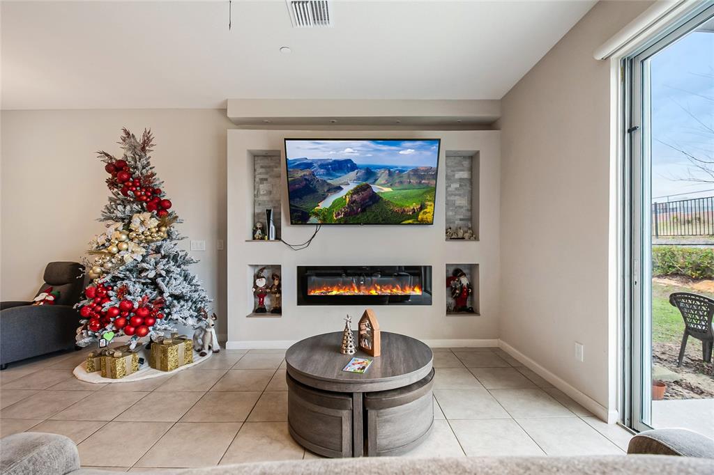 1943 Holden Ridge Ln. Clermont, FL 34715 - Photo 22 of 59 a living room with furniture and a potted plant