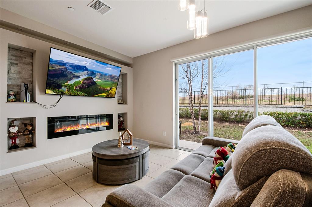1943 Holden Ridge Ln. Clermont, FL 34715 - Photo 23 of 59 a living room with furniture and a floor to ceiling window