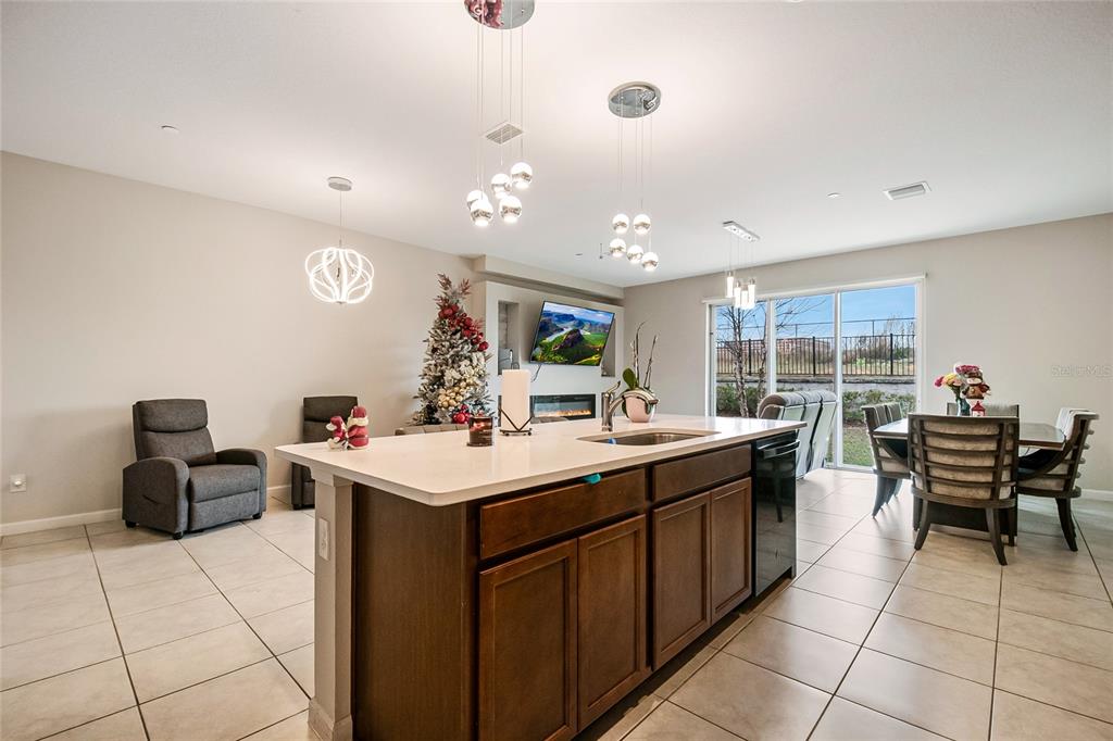 1943 Holden Ridge Ln. Clermont, FL 34715 - Photo 27 of 59 a kitchen with a sink and chairs