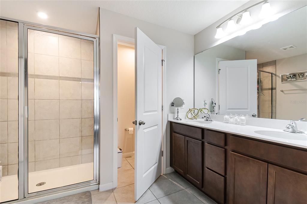 1943 Holden Ridge Ln. Clermont, FL 34715 - Photo 37 of 59 a bathroom with a double vanity sink mirror and shower