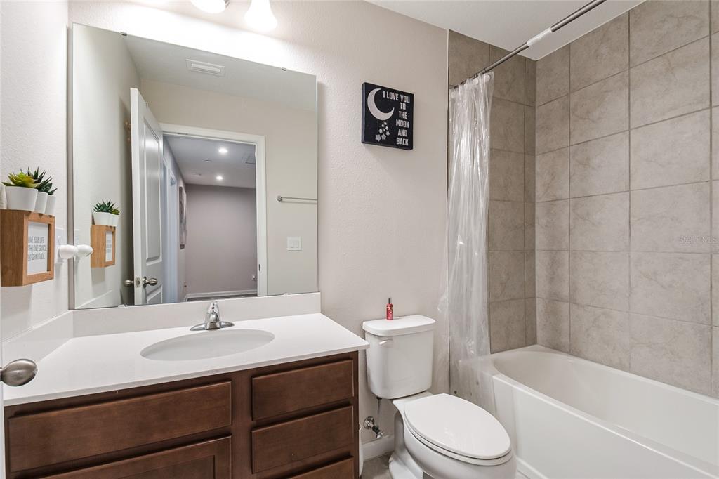 1943 Holden Ridge Ln. Clermont, FL 34715 - Photo 43 of 59 a bathroom with a sink toilet a mirror and shower