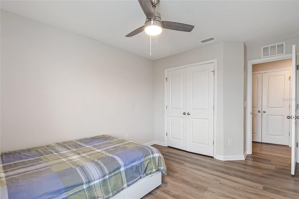 1943 Holden Ridge Ln. Clermont, FL 34715 - Photo 44 of 59 a bedroom with a bed and a chandelier