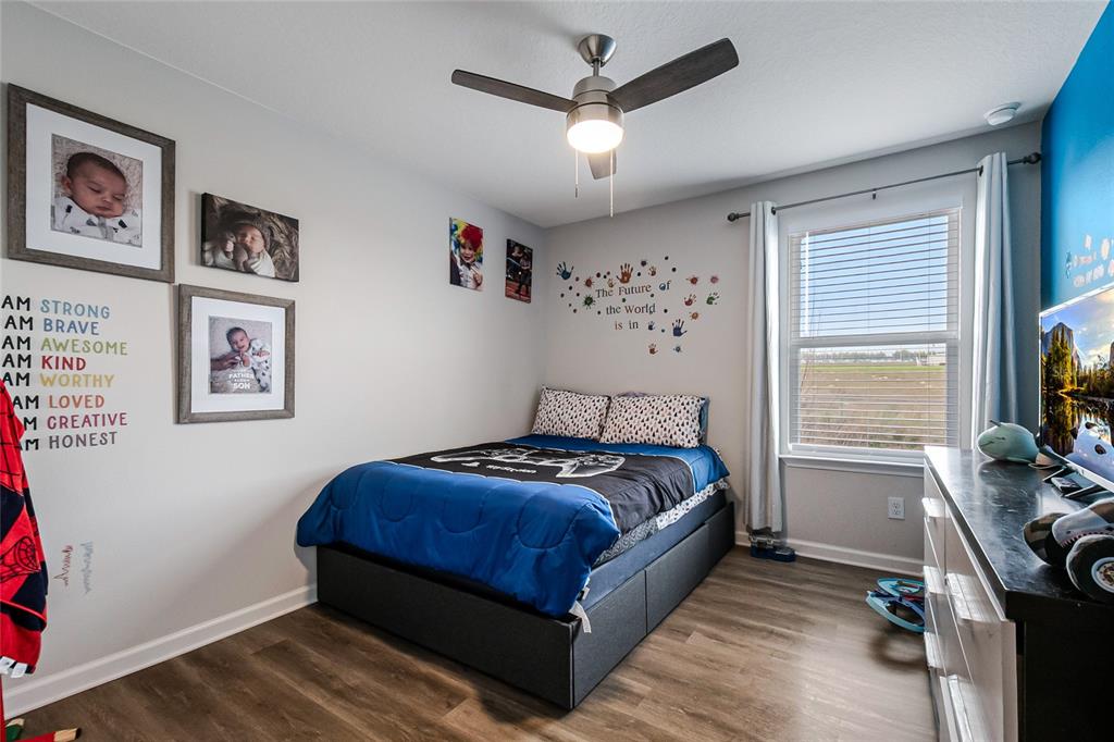 1943 Holden Ridge Ln. Clermont, FL 34715 - Photo 46 of 59 a bedroom with a bed and a window