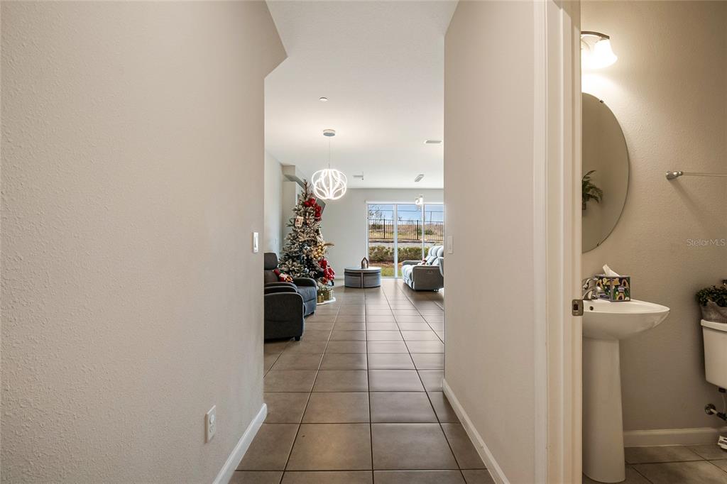1943 Holden Ridge Ln. Clermont, FL 34715 - Photo 10 of 59 a view of a hallway and a dining room with furniture